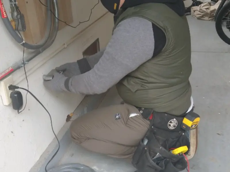 Electrician performing outlet wiring in a Bogalusa garage